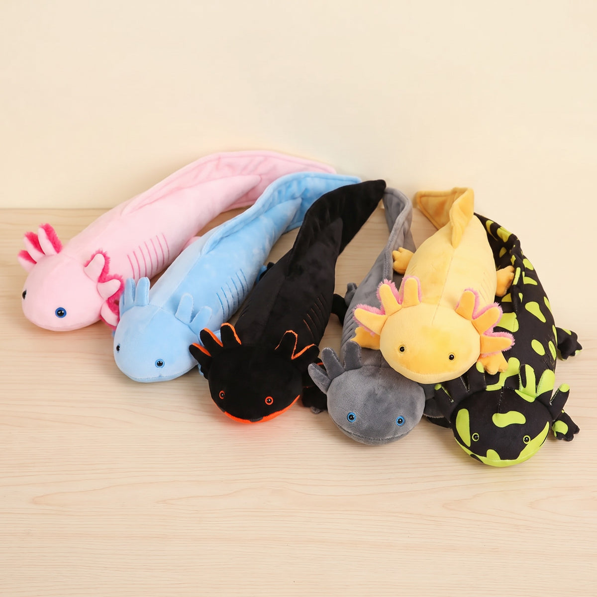 Realistic axolotl plush in pink, blue, black, grey, yellow and spotted