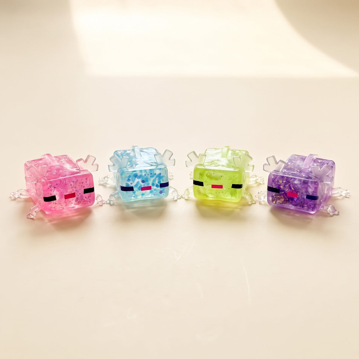 Axolotl squishy in pink, sky blue, green and purple