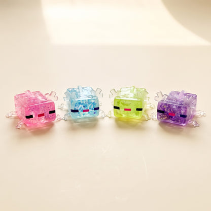 Axolotl squishy in pink, sky blue, green and purple